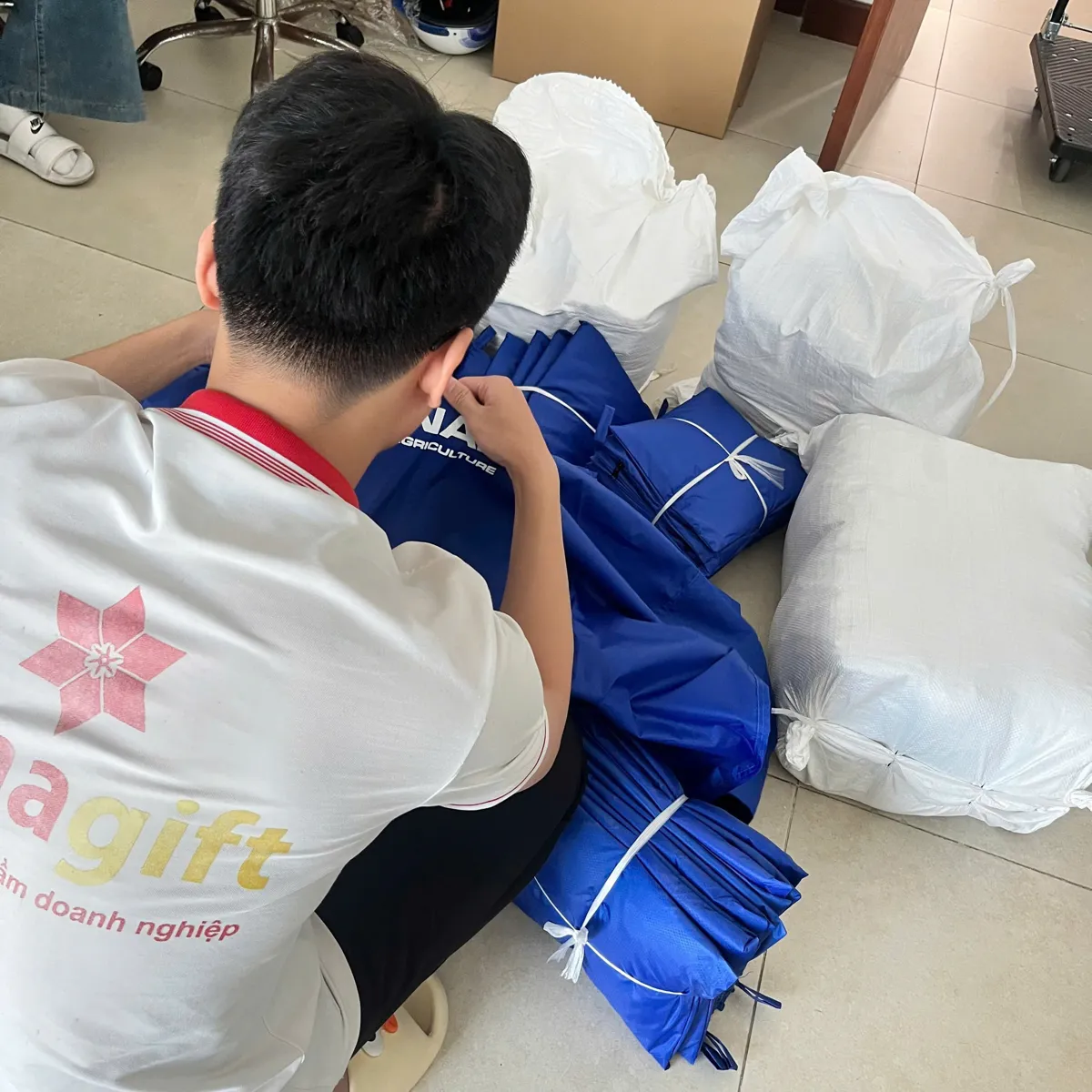 Nhân viên DonaGift kiểm đếm hàng may in logo trước khi đóng bao